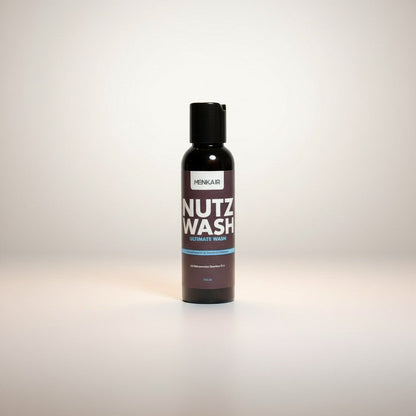 Menkair Nutz Wash intimate wash bottle on a white towel, promoting daily hygiene and freshness.